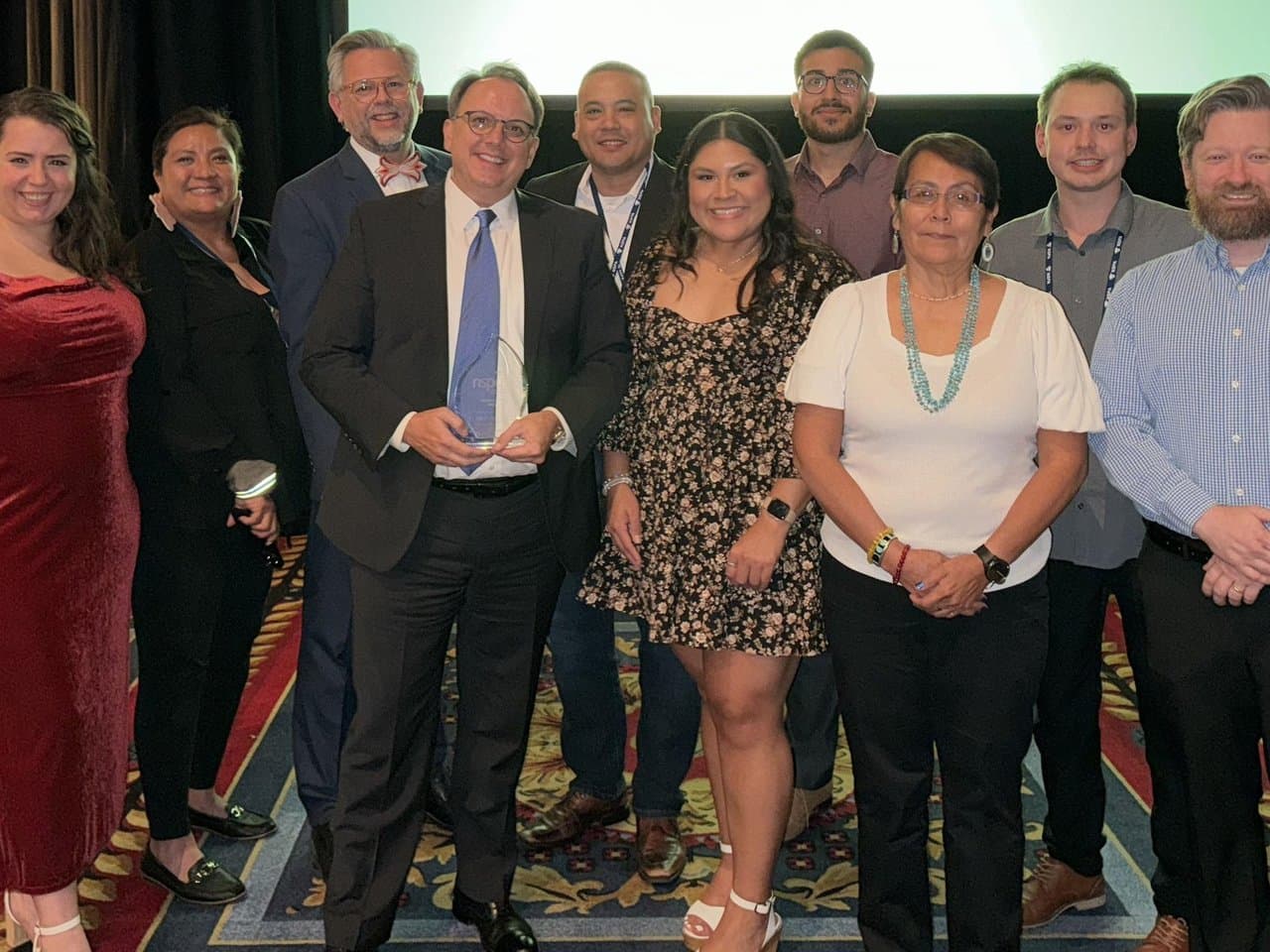 Indigenous Education, Inc. staff with the John Garland awardee at the 2023 NSPA conference