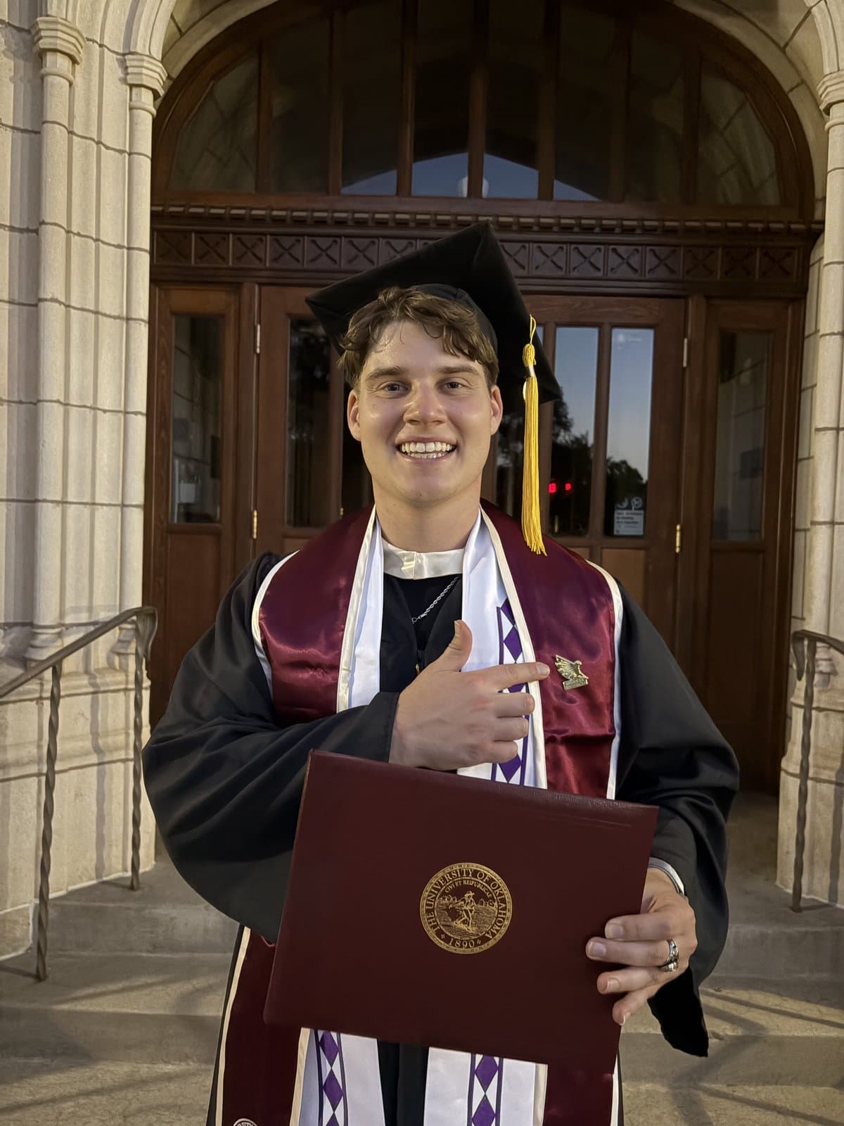 Brysan Redwine, Cobell Undergraduate Scholar, at his University of Oklahoma graduation